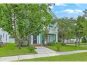 Charming two-story home with a porch and well-maintained lawn surrounded by mature trees at 300 Foxglove Ave, Summerville, SC 29483