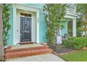 Inviting covered porch with swing seating and lush landscaping at 300 Foxglove Ave, Summerville, SC 29483