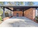 Attached brick carport offering covered parking at 313 Runnymede Ln, Summerville, SC 29485
