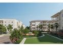 Condo buildings surrounded by lush greenery and flowering trees at 325 Longshore St # 1122, Daniel Island, SC 29492