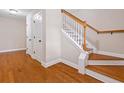 Elegant staircase featuring hardwood steps, white risers, and a stained wood railing; hardwood floor on landing at 3588 Bagley Dr, Mount Pleasant, SC 29466