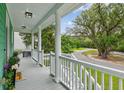 Inviting front porch featuring elegant white columns and a scenic neighborhood view at 3636 Purple Martin Ct, Mount Pleasant, SC 29466