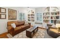 Stylish living room featuring a leather sofa, built-in shelving, and a rustic wooden coffee table with storage at 38 Colleton Dr, Charleston, SC 29407