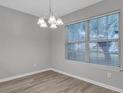 Cozy dining area with modern chandelier, neutral walls and large window at 4054 Cedars Pkwy # C, North Charleston, SC 29420