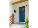 Close-up of a blue front door with glass panes, complemented by a brick facade and wooden accents at 4939 Ashby Ave, North Charleston, SC 29405