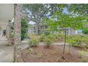 Brick apartment building showcasing mature landscaping, walkways and access to the upper units at 516 Arlington Dr # B4, Charleston, SC 29414