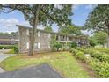 Two-story brick apartment building featuring well-maintained landscaping and outdoor living spaces at 516 Arlington Dr # B4, Charleston, SC 29414