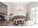 Bright dining room with a rustic wood table and a sliding glass door to the yard at 519 Purple Finch Rd, Summerville, SC 29486