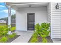 Inviting entryway with a stylish black front door, decorative plants, and house number 523 at 523 Purple Finch Rd, Summerville, SC 29486