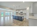 Open-concept kitchen boasts a large island, stainless steel appliances, and seamless connection to the dining area at 523 Purple Finch Rd, Summerville, SC 29486