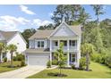 Beautiful two-story home with a welcoming front porch and well-maintained lawn, creating curb appeal at 5541 Alpine Dr, Summerville, SC 29483