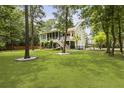 Expansive backyard with lush lawn, mature trees, screened porch, and beautiful landscaping at 800 Enclave Ter, Summerville, SC 29483