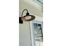 Close up of the stylish black and gold exterior light fixture at 819 Burger St, Charleston, SC 29407