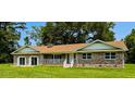 Charming single-story brick home with a covered front porch and well manicured lawn at 840 Brittle Bank Rd, Walterboro, SC 29488
