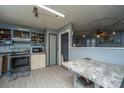 This kitchen includes an oven, refrigerator and an adjoining living space at 1004 Miles Jamison Rd, Summerville, SC 29485
