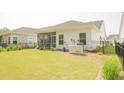 Expansive backyard featuring lush green grass, a screened porch, a fenced yard, and a Generac generator at 1030 Grace Field Ave, Summerville, SC 29485