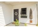 Charming front entryway featuring a black door with wreath, side window with shutter, and decorative accents at 1030 Grace Field Ave, Summerville, SC 29485