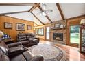 Cozy living room featuring a fireplace, exposed beams, and comfortable leather seating at 107 Salina Ln, Goose Creek, SC 29445