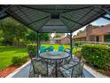 Relaxing outdoor space with a gazebo, seating, and lush green backyard with brick accents at 107 Salina Ln, Goose Creek, SC 29445
