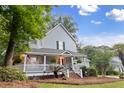 Charming covered front porch features white railings and steps, offering a relaxing outdoor space at 111 Long Bow Rd, Summerville, SC 29485