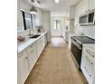 Modern kitchen featuring white cabinets, stainless steel appliances, and butcher block countertops at 1119 Morning Glory Ct, Mount Pleasant, SC 29464