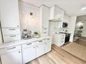Bright, modern kitchen with white cabinets, stainless steel appliances, and wood floors at 1119 Morning Glory Ct, Mount Pleasant, SC 29464