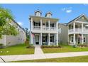 Attractive two-story home with a classic design, showcasing a spacious porch and manicured lawn at 113 Osprey Ridge Ln, Summerville, SC 29483