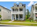 Beautiful two-story home with a traditional facade, highlighted by a charming porch and dormer windows at 113 Osprey Ridge Ln, Summerville, SC 29483