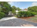 Home exterior showcasing a well-maintained asphalt driveway and lush greenery, providing a serene and inviting entrance at 1151 Camellia Dr, Mount Pleasant, SC 29464