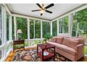 Bright sunroom with large windows offering serene wooded views and a comfortable seating area at 127 White Pine Way, Summerville, SC 29485