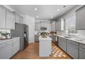 Modern kitchen with gray cabinets, stainless steel appliances, and a center island at 1309 Berry Grove Dr, Summerville, SC 29485