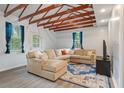 Bright living room with exposed wood beams, a large comfortable sectional, and blue accent rug at 14 Aldene Ave, Goose Creek, SC 29445