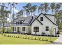 Eye-catching exterior with white siding, black trim, and manicured landscaping enhancing curb appeal at 142 Argosy Dr, Summerville, SC 29483