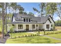 Charming home featuring a well-manicured lawn, dark trim, and classic farmhouse architectural details at 142 Argosy Dr, Summerville, SC 29483