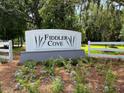 Fiddler Cove neighborhood sign with landscaping and white fence at 1427 Dahlia Rd, Mount Pleasant, SC 29464