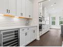 Spacious kitchen with white cabinetry, stainless steel wine cooler, and elegant countertops at 1427 Dahlia Rd, Mount Pleasant, SC 29464