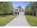Charming two-story home with well-maintained lawn, driveway and attached one car garage at 1506 Southwick Dr, Johns Island, SC 29455