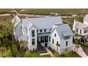 An aerial view of the property, featuring lovely landscaping, a waterway, and a metal roof at 156 Nobels Point St, Charleston, SC 29492