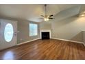 Bright living room with wood floors, fireplace, ceiling fan, and entry door with decorative glass at 1705 Falcon Cove Ln, Hanahan, SC 29410