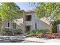 Multi-story condo building with a light exterior, surrounded by lush landscaping and mature trees at 1815 Long Bend Dr, Seabrook Island, SC 29455
