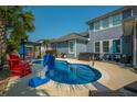 Backyard pool area, complete with comfortable seating, lounge chairs, a hot tub and ample space for relaxation at 185 Red Leaf Blvd, Moncks Corner, SC 29461
