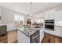 Open-concept kitchen with granite counters, stainless appliances, and a view into the living area at 2208 Primus Rd, Mount Pleasant, SC 29466