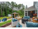 Beautiful backyard with patio, gazebo, outdoor furniture, and a lush lawn, perfect for entertaining at 259 Camber Rd, Huger, SC 29450