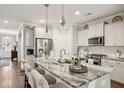 Spacious kitchen features a large island, stainless steel appliances, and white cabinets at 259 Camber Rd, Huger, SC 29450