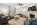 Cozy living room with fireplace, plush seating, and large windows offering ample natural light at 259 Camber Rd, Huger, SC 29450