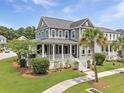 Charming two-story home with a spacious porch and lush landscaping at 2769 Rivertowne Pkwy, Mount Pleasant, SC 29466
