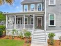 Charming front porch with a welcoming entryway and lush landscaping at 2769 Rivertowne Pkwy, Mount Pleasant, SC 29466
