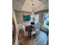 Bright dining room with modern chandelier, wainscoting, and large windows at 2844 Curran Pl, Mount Pleasant, SC 29466