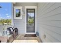 Cozy front porch area featuring comfortable wicker furniture and a glass-paneled front door at 2928 Tranquility Rd, Mount Pleasant, SC 29466