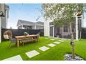 Backyard showcasing a wooden dining table and a tree for a relaxing outdoor experience at 3 Clearblue Loop, Summerville, SC 29486